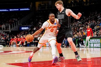 Mar 12, 2026; Atlanta, Georgia, USA; Atlanta Hawks forward Jonathan Kuminga (0) dribbles against Brooklyn Nets forward Danny Wolf (2) during the second half at State Farm Arena. Mandatory Credit: Dale Zanine-Imagn Images