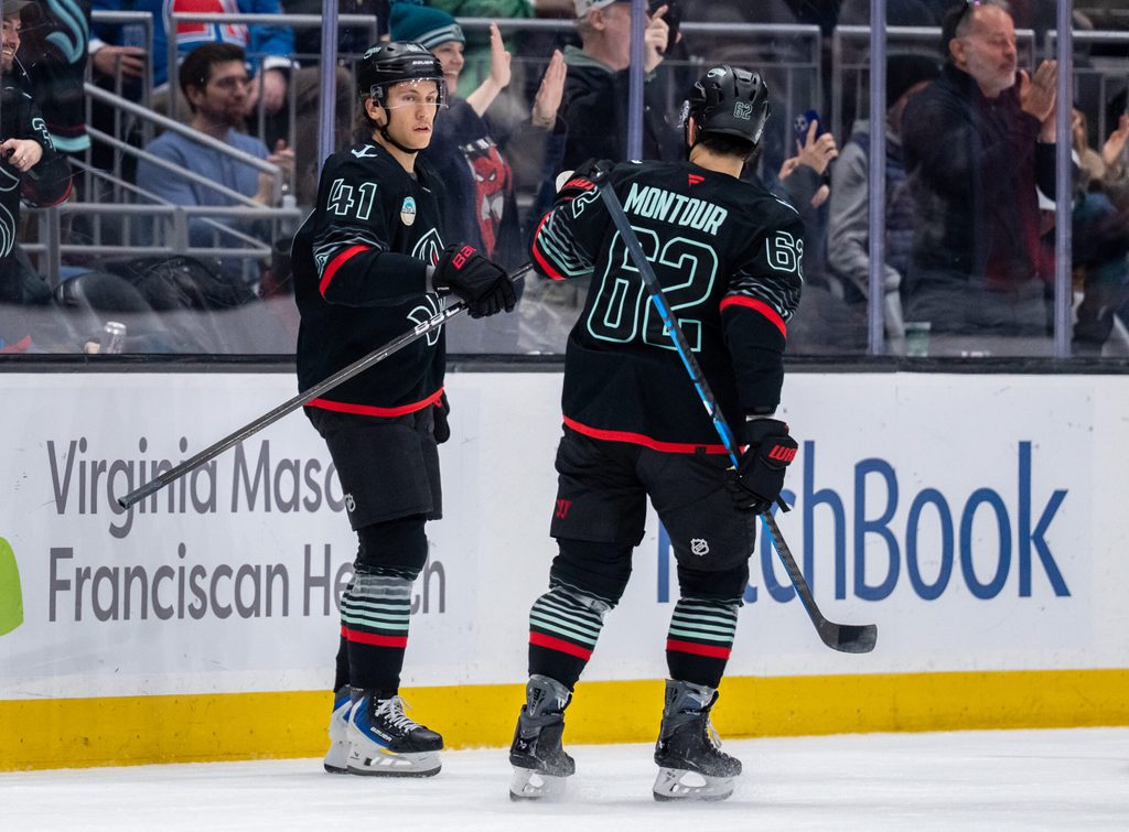 Mar 12, 2026; Seattle, Washington, USA; Seattle Kraken defenseman Ryker Evans (41) is congratulated by Seattle Kraken defenseman Brandon Montour (62) after scoring a goal during the second period against the Colorado Avalanche at Climate Pledge Arena. Mandatory Credit: Stephen Brashear-Imagn Images
