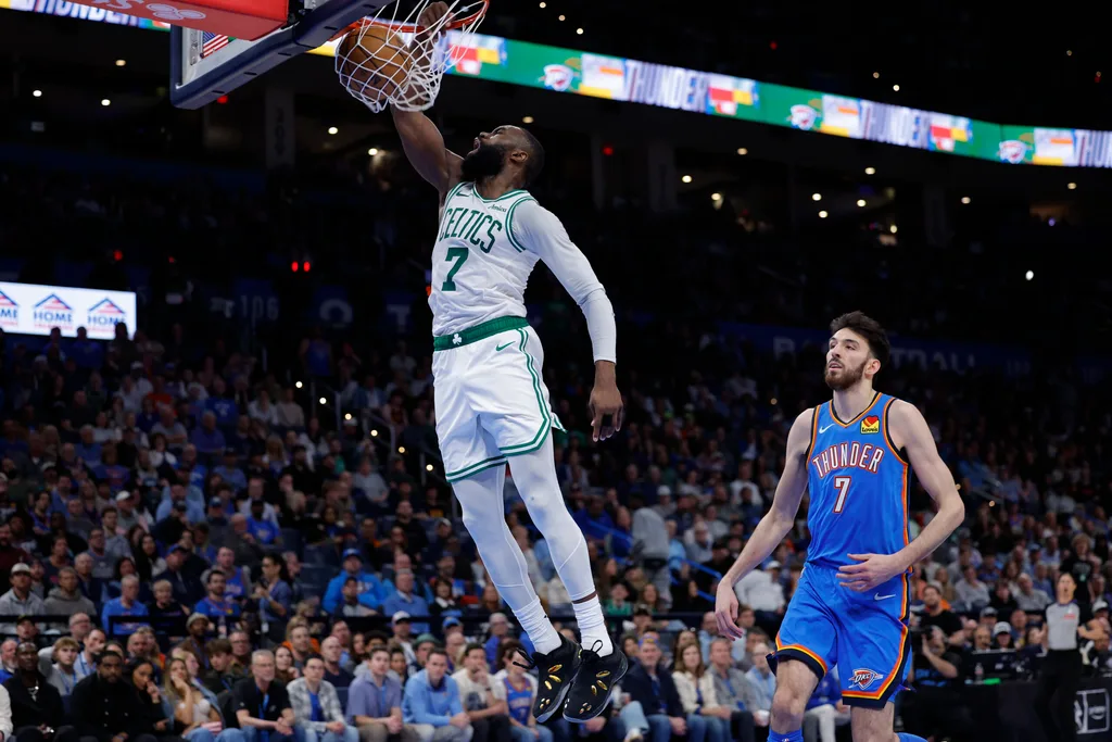 Mar 12, 2026; Oklahoma City, Oklahoma, USA; Boston Celtics guard/forward Jaylen Brown (7) goes up for a dunk in front of Oklahoma City Thunder center/forward Chet Holmgren (7) during the fourth quarter at Paycom Center. Mandatory Credit: Alonzo Adams-Imagn Images
