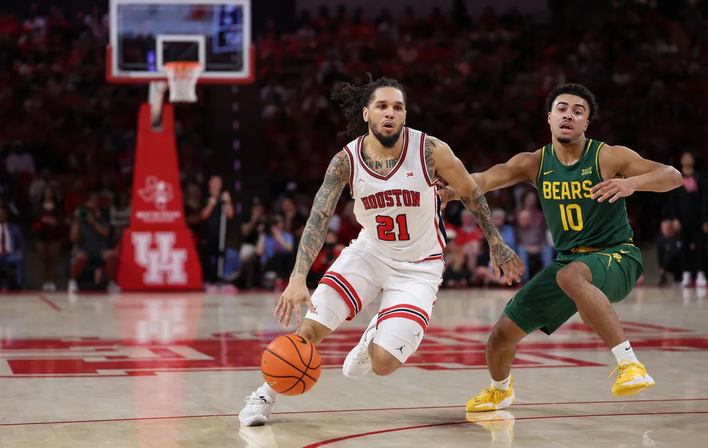 Mar 4, 2026; Houston, Texas, USA; Houston Cougars guard Emanuel Sharp (21) dribbles against Baylor Bears guard Isaac Williams (10) in the first half at Fertitta Center. Mandatory Credit: Thomas Shea-Imagn Images