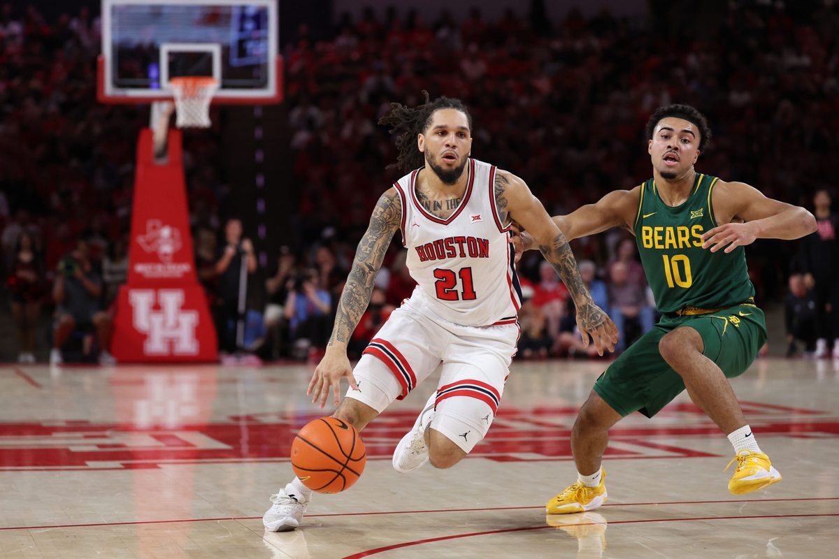 Mar 4, 2026; Houston, Texas, USA; Houston Cougars guard Emanuel Sharp (21) dribbles against Baylor Bears guard Isaac Williams (10) in the first half at Fertitta Center. Mandatory Credit: Thomas Shea-Imagn Images