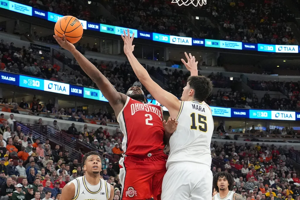 Mar 13, 2026; Chicago, IL, USA; Michigan Wolverines center Aday Mara (15) defends Ohio State Buckeyes guard Bruce Thornton (2) during the second half at United Center. Mandatory Credit: David Banks-Imagn Images