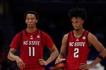 Mar 12, 2026; Charlotte, NC, USA; NC State Wolfpack guard Quadir Copeland (11) and guard Jr. Paul McNeil (2) in the final seconds during the second half against the Virginia Cavaliers at Spectrum Center. Mandatory Credit: Jim Dedmon-Imagn Images
