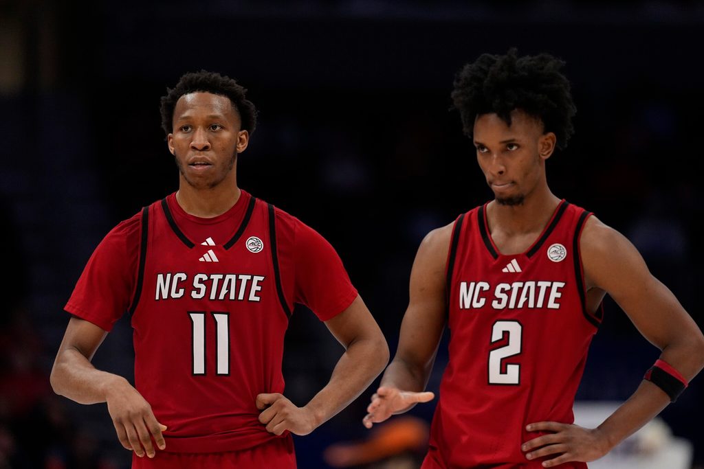 Mar 12, 2026; Charlotte, NC, USA; NC State Wolfpack guard Quadir Copeland (11) and guard Jr. Paul McNeil (2) in the final seconds during the second half against the Virginia Cavaliers at Spectrum Center. Mandatory Credit: Jim Dedmon-Imagn Images