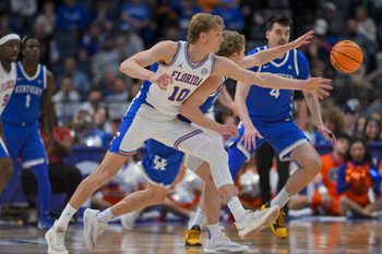 Mar 13, 2026; Nashville, TN, USA;  Florida Gators forward Thomas Haugh (10) and Kentucky Wildcats guard Collin Chandler (5) fight for the loose ball during the second half at Bridgestone Arena. Mandatory Credit: Steve Roberts-Imagn Images