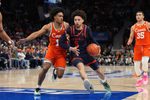 Mar 13, 2026; Charlotte, NC, USA; Virginia Cavaliers guard Sam Lewis (5) with the ball as Miami (FL) Hurricanes guard Tru Washington (10) defends in the second half at Spectrum Center. Mandatory Credit: Bob Donnan-Imagn Images