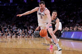Mar 13, 2026; New York, NY, USA; Connecticut Huskies forward Alex Karaban (11) drives to the basket around Georgetown Hoyas forward Caleb Williams (4) during the second half at Madison Square Garden. Mandatory Credit: Brad Penner-Imagn Images
