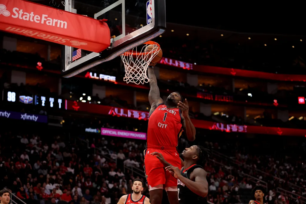 Mar 13, 2026; Houston, Texas, USA; New Orleans Pelicans forward Zion Williamson (1) dunks against Houston Rockets forward Dorian Finney-Smith (2) during the fourth quarter at Toyota Center. Mandatory Credit: Erik Williams-Imagn Images