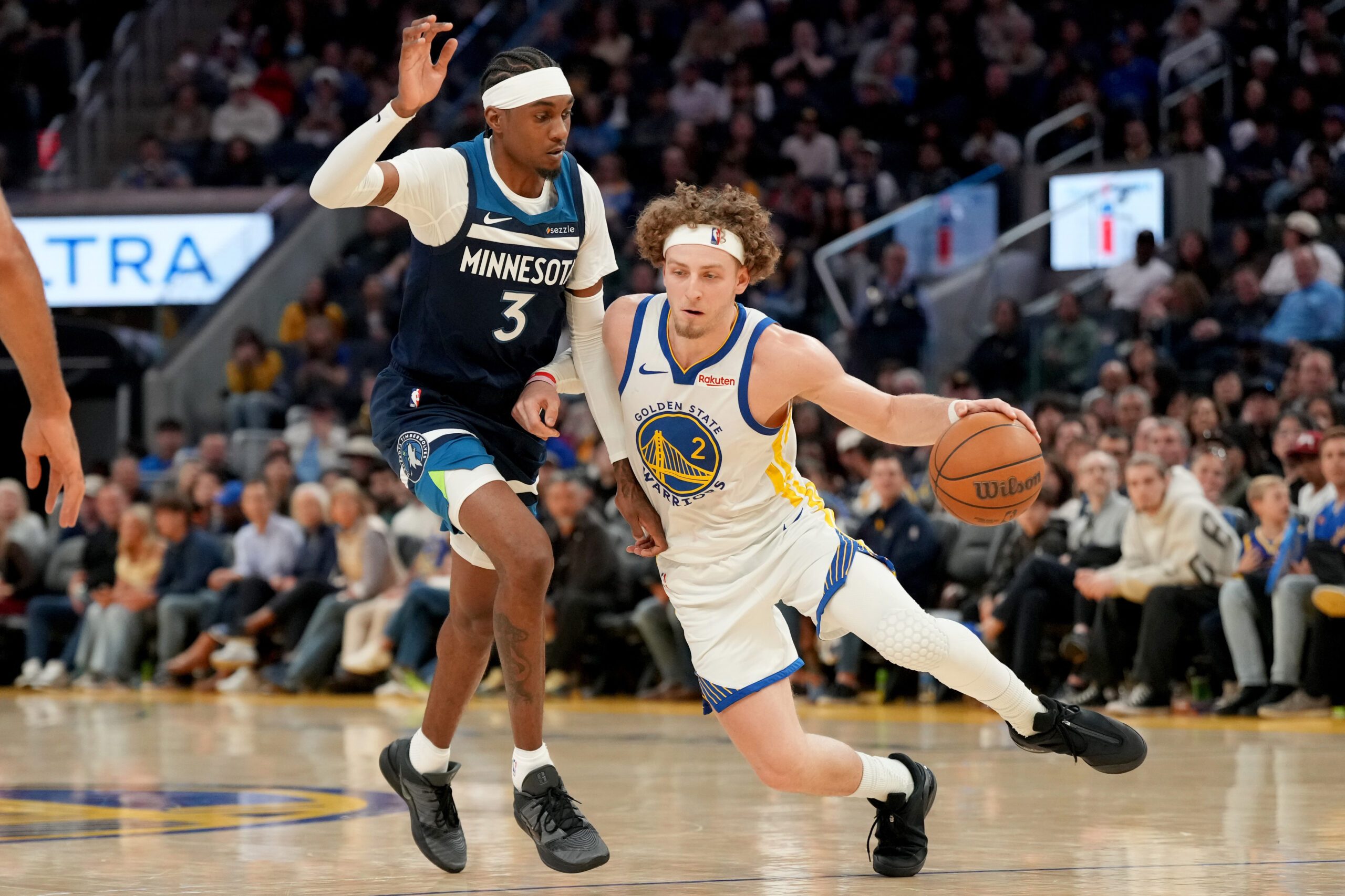 Mar 13, 2026; San Francisco, California, USA; Golden State Warriors guard Brandin Podziemski (2) dribbles the ball next to Minnesota Timberwolves forward Jaden McDaniels (3) in the fourth quarter at the Chase Center. Mandatory Credit: Cary Edmondson-Imagn Images