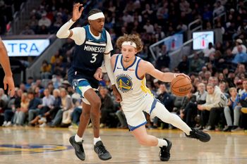 Mar 13, 2026; San Francisco, California, USA; Golden State Warriors guard Brandin Podziemski (2) dribbles the ball next to Minnesota Timberwolves forward Jaden McDaniels (3) in the fourth quarter at the Chase Center. Mandatory Credit: Cary Edmondson-Imagn Images