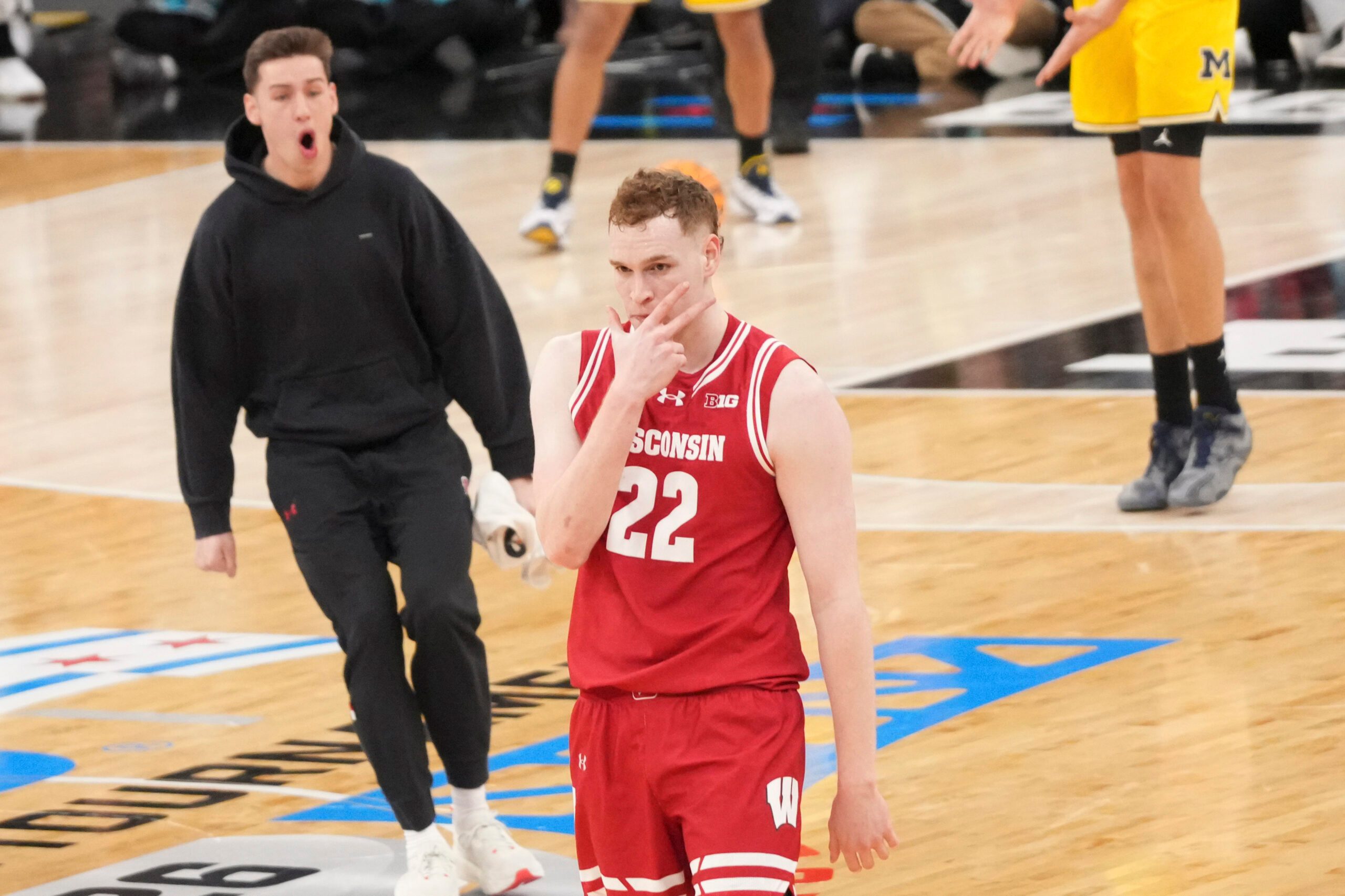 Mar 14, 2026; Chicago, IL, USA; Wisconsin Badgers forward Austin Rapp (22) reacts after making a three point basket against the Michigan Wolverines during the first half at United Center. Mandatory Credit: David Banks-Imagn Images