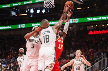 Mar 14, 2026; Atlanta, Georgia, USA; Atlanta Hawks forward Onyeka Okongwu (17) and Milwaukee Bucks center Myles Turner (3) and forward Kyle Kuzma (18) go up for a rebound in the third quarter at State Farm Arena. Mandatory Credit: Brett Davis-Imagn Images