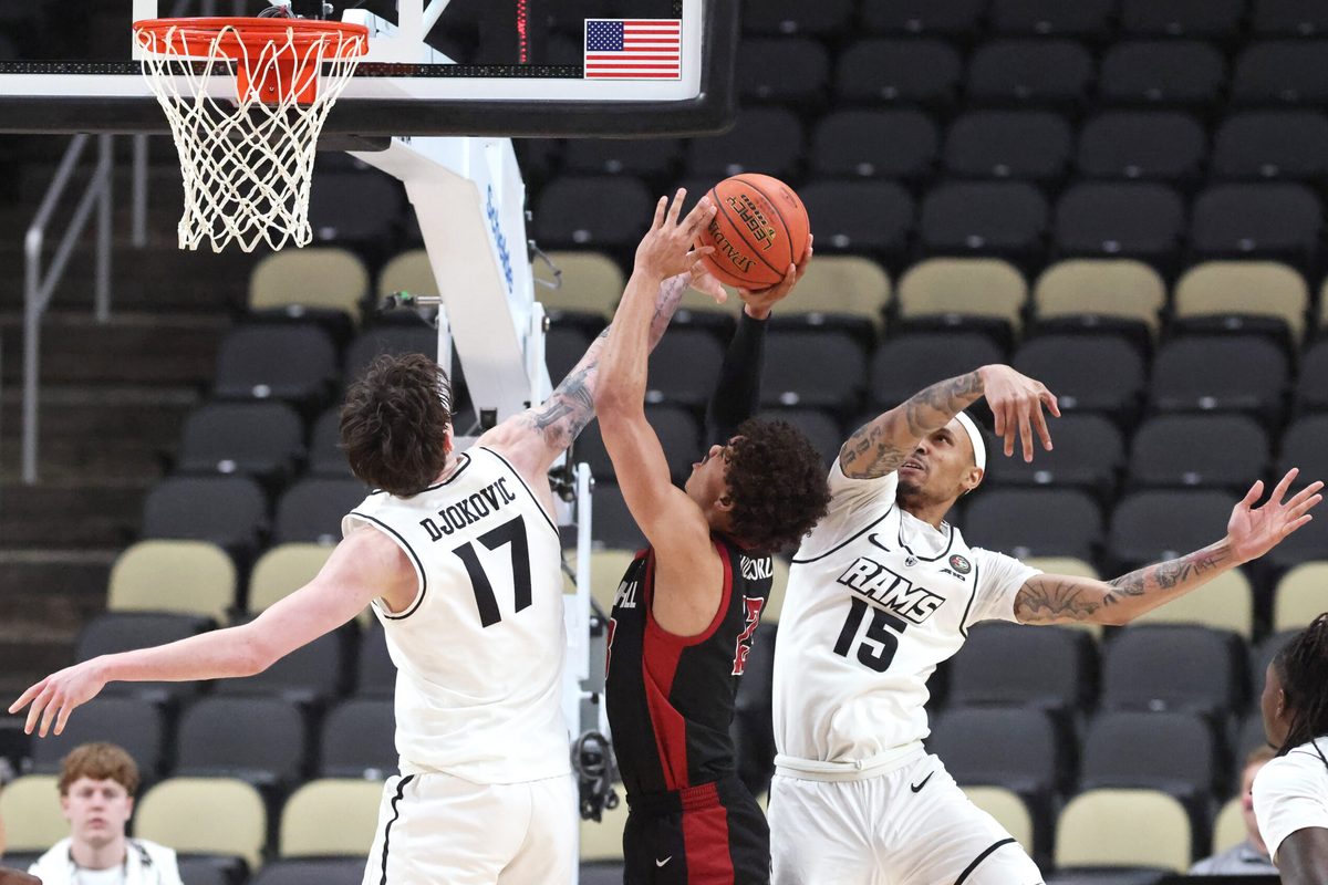 Mar 14, 2026; Pittsburgh, PA, USA;  VCU Rams forward Lazar Djokovic (17) and guard Tyrell Ward (15) defend Saint Joseph's Hawks guard Austin Willgford (13) during the second half in an Atlantic 10 Conference Tournament semifinal game at PPG Paints Arena. Mandatory Credit: Charles LeClaire-Imagn Images