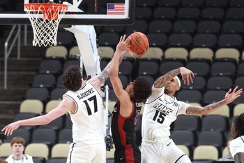 Mar 14, 2026; Pittsburgh, PA, USA;  VCU Rams forward Lazar Djokovic (17) and guard Tyrell Ward (15) defend Saint Joseph's Hawks guard Austin Willgford (13) during the second half in an Atlantic 10 Conference Tournament semifinal game at PPG Paints Arena. Mandatory Credit: Charles LeClaire-Imagn Images