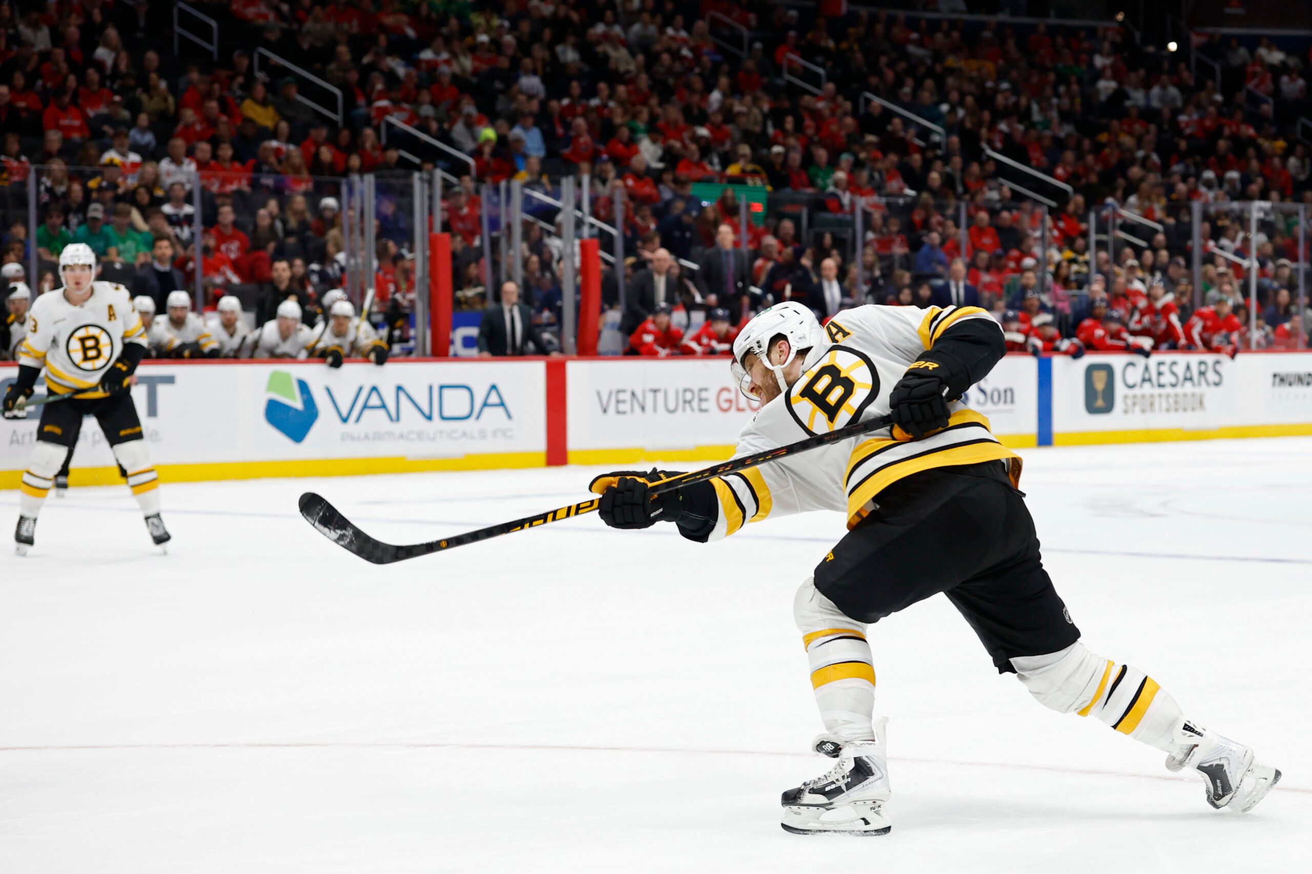 Mar 9, 2026; Washington, District of Columbia, USA; Boston Bruins right wing David Pastrnak (88) shoots the puck against the Washington Capitals in overtime at Capital One Arena. Mandatory Credit: Geoff Burke-Imagn Images