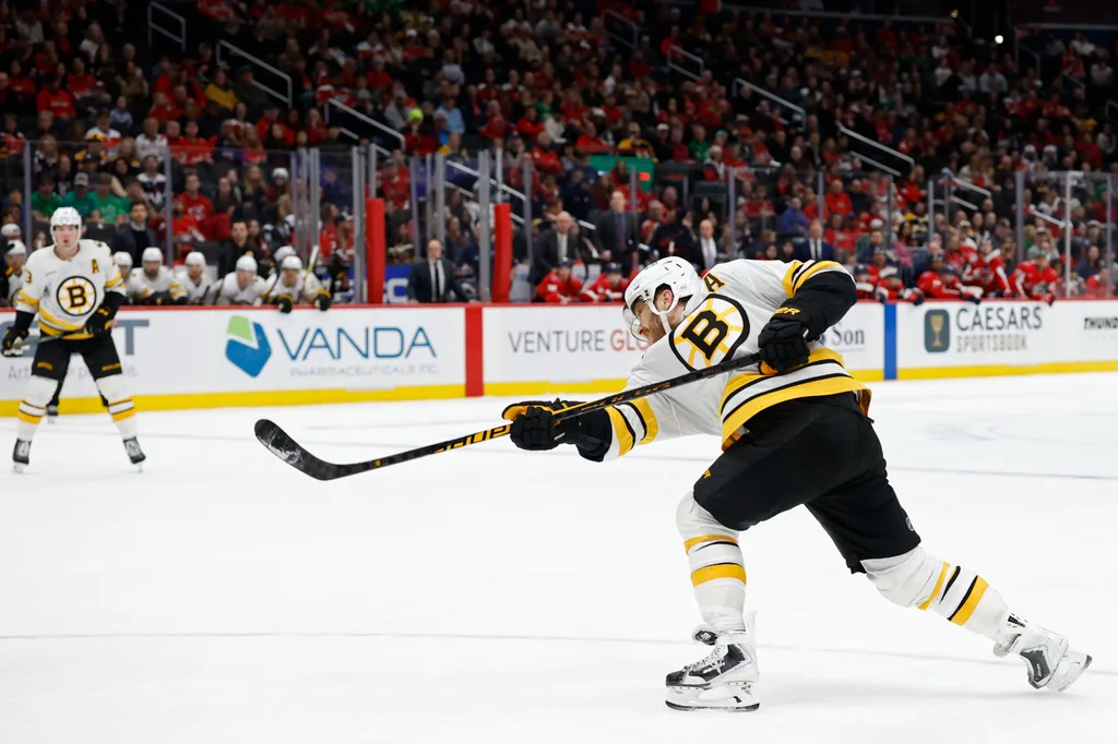 Mar 9, 2026; Washington, District of Columbia, USA; Boston Bruins right wing David Pastrnak (88) shoots the puck against the Washington Capitals in overtime at Capital One Arena. Mandatory Credit: Geoff Burke-Imagn Images