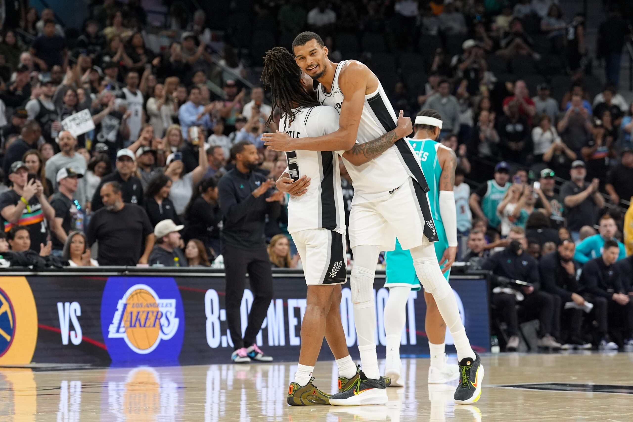 Mar 14, 2026; San Antonio, Texas, USA;  San Antonio Spurs forward Victor Wembanyama (1) hugs guard Stephon Castle (5) after the game against the Charlotte Hornets at Frost Bank Center. Mandatory Credit: Daniel Dunn-Imagn Images