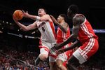 Mar 14, 2026; Kansas City, MO, USA; Arizona Wildcats forward Ivan Kharchenkov (8) drives to the hoop past Houston Cougars forward Chase McCarty (24) during the first half during the men's Big 12 Conference Tournament Championship at T-Mobile Center. Mandatory Credit: William Purnell-Imagn Images