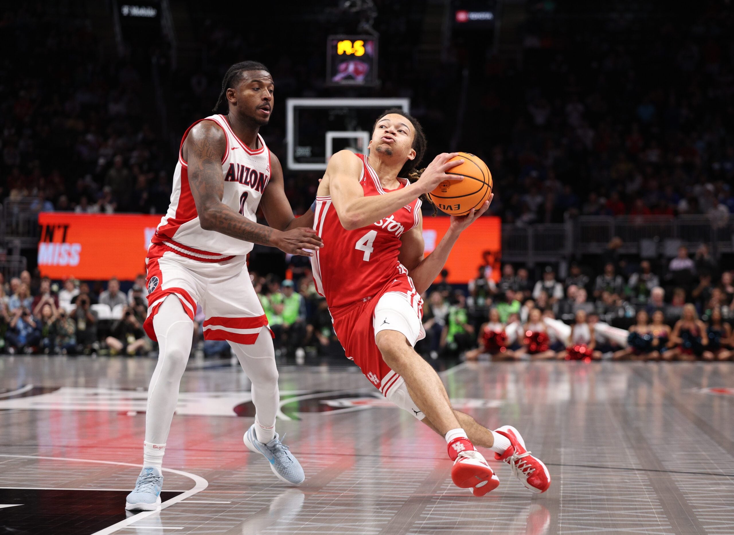 Mar 14, 2026; Kansas City, MO, USA; Houston Cougars guard Kingston Flemings (4) drives to the hoop past Arizona Wildcats guard Jaden Bradley (0) during the second half during the men's Big 12 Conference Tournament Championship at T-Mobile Center. Mandatory Credit: William Purnell-Imagn Images