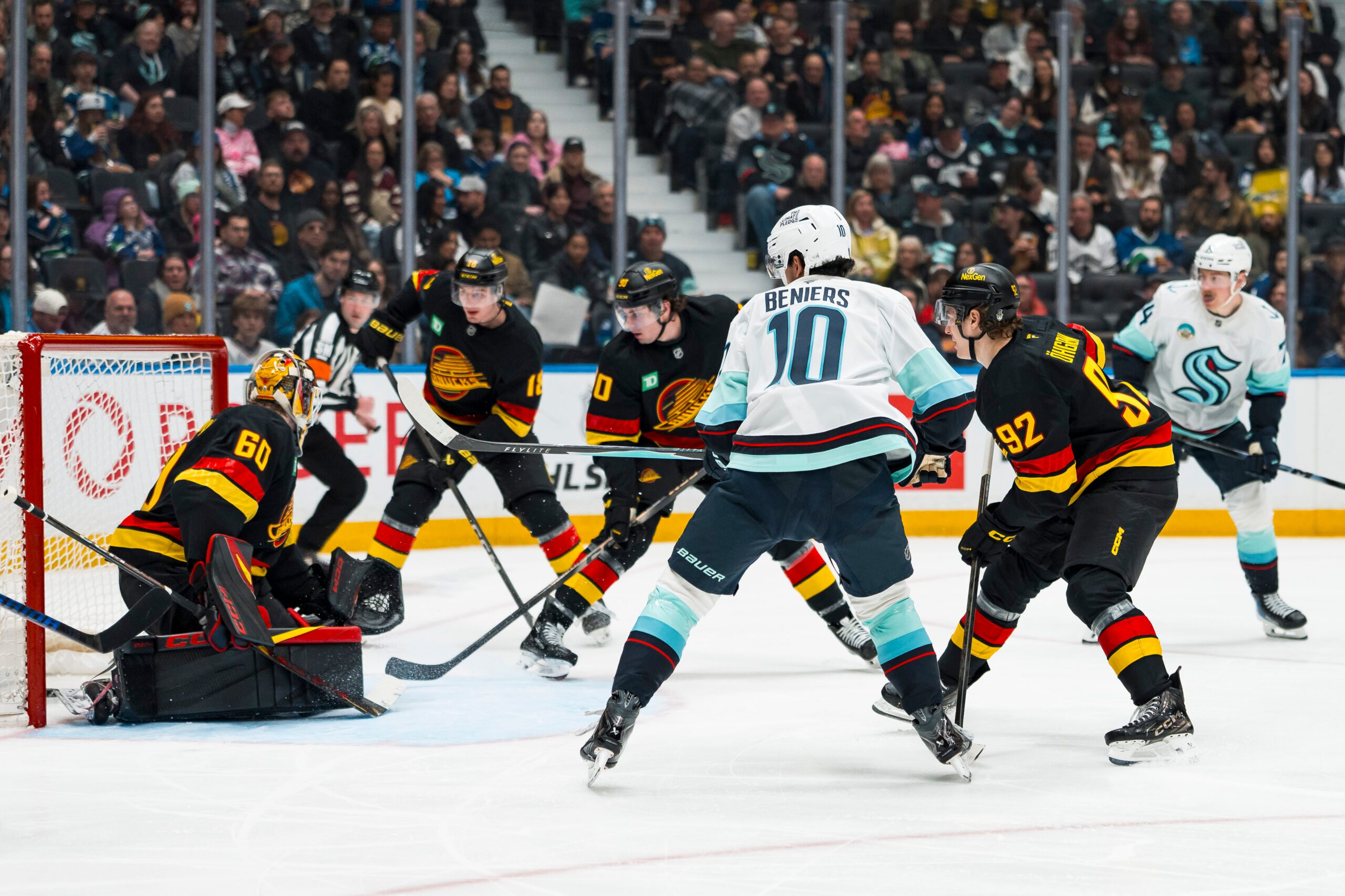 Mar 14, 2026; Vancouver, British Columbia, CAN; Vancouver Canucks forward Liam Ohgren (92) and forward Drew O'Connor (18) and defenseman Victor Mancini (90) watch as Seattle Kraken forward Matty Beniers (10) scores on goalie Nikita Tolopilo (60) in the third period at Rogers Arena. Mandatory Credit: Bob Frid-Imagn Images