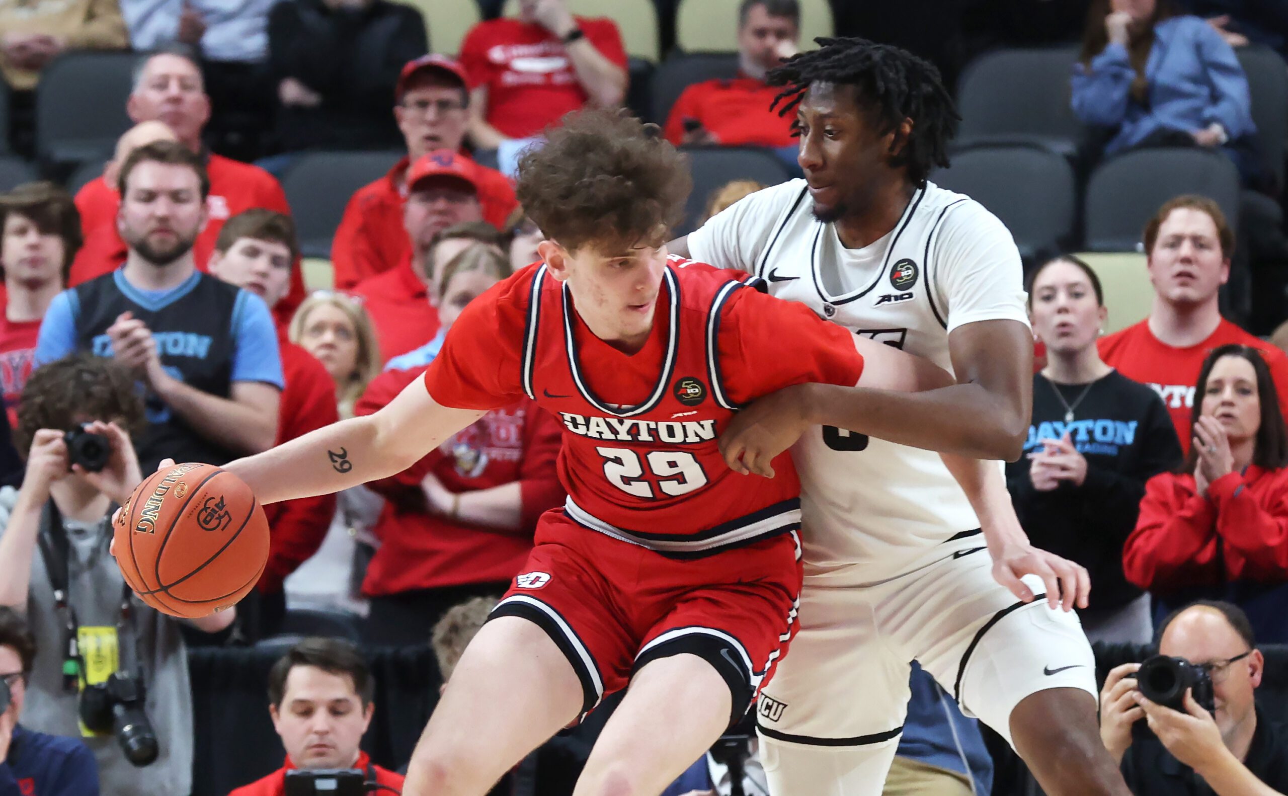 Mar 15, 2026; Pittsburgh, PA, USA; Dayton Flyers forward Amael L'etang (29) dribbles while closely guarded by VCU Rams forward Michael Belle (right) during the second half in the Atlantic 10 Conference Tournament Championship game at PPG Paints Arena. Mandatory Credit: Charles LeClaire-Imagn Images