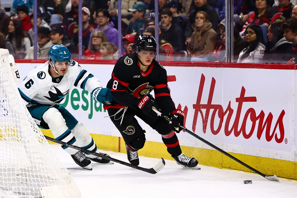Mar 15, 2026; Ottawa, Ontario, CAN; Ottawa Senators center Tim Stutzle (18) skates with the puck against San Jose Sharks defenseman Sam Dickinson (6) during the first period at Canadian Tire Centre. Mandatory Credit: Keito Newman-Imagn Images