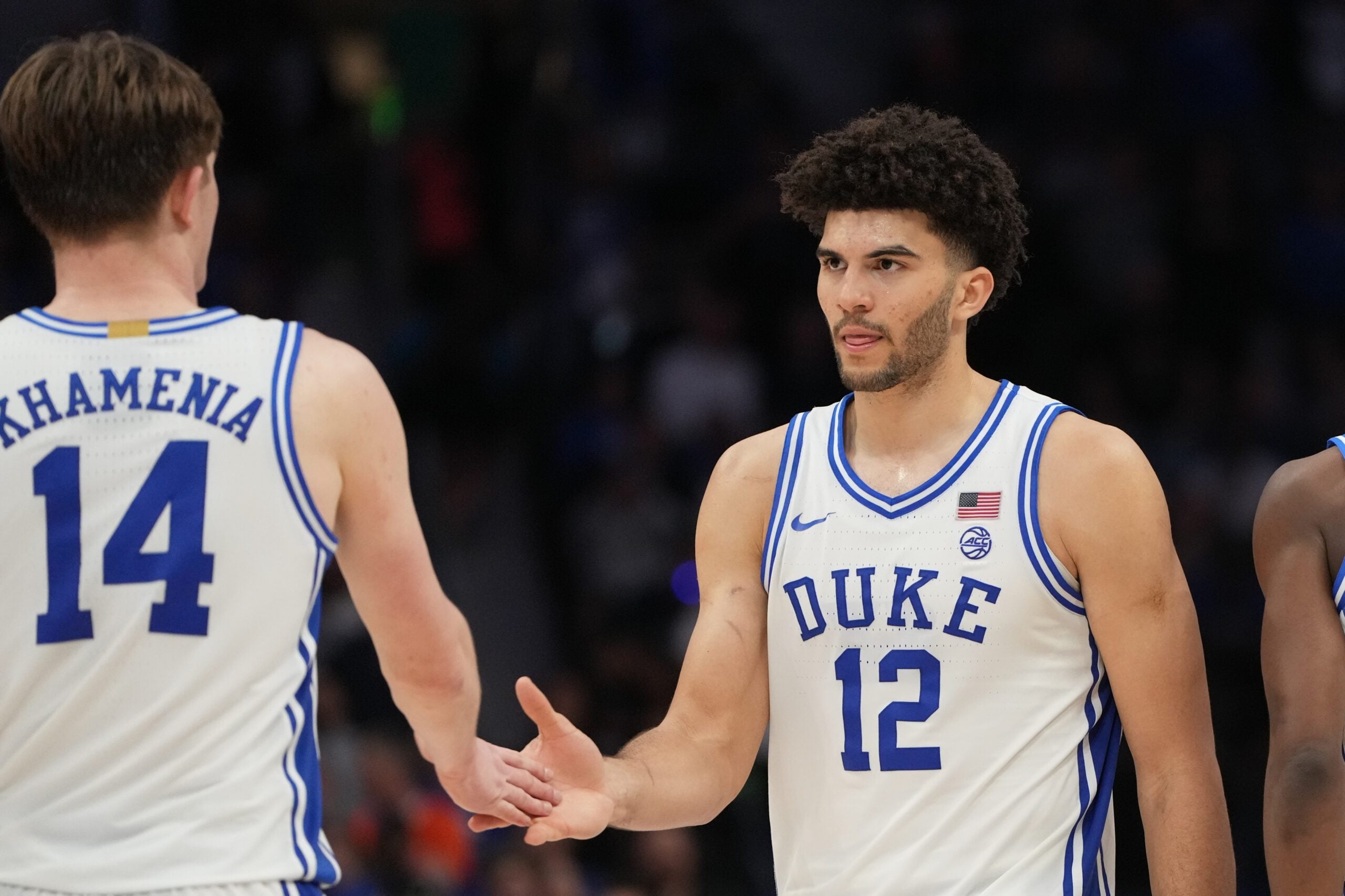 Mar 14, 2026; Charlotte, NC, USA; Duke Blue Devils forward Cameron Boozer (12) reacts with guard Nikolas Khamenia (14) in the second half during the men's ACC Conference Tournament Championship at Spectrum Center. Mandatory Credit: Bob Donnan-Imagn Images
