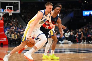 Mar 16, 2026; Washington, District of Columbia, USA; Golden State Warriors center Kristaps Porzingis (7) dribbles past Washington Wizards forward Julian Reese (15) during the second half at Capital One Arena. Mandatory Credit: Brad Mills-Imagn Images