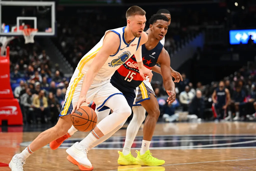 Mar 16, 2026; Washington, District of Columbia, USA; Golden State Warriors center Kristaps Porzingis (7) dribbles past Washington Wizards forward Julian Reese (15) during the second half at Capital One Arena. Mandatory Credit: Brad Mills-Imagn Images
