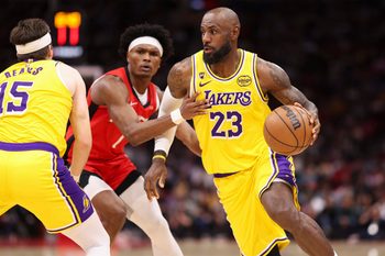 Mar 16, 2026; Houston, Texas, USA; Los Angeles Lakers forward LeBron James (23) dribbles with the ball around Houston Rockets guard Amen Thompson (1) during the third quarter at Toyota Center. Mandatory Credit: Troy Taormina-Imagn Images