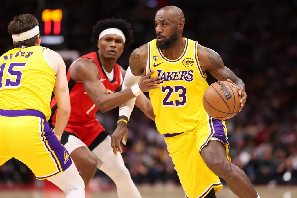 Mar 16, 2026; Houston, Texas, USA; Los Angeles Lakers forward LeBron James (23) dribbles with the ball around Houston Rockets guard Amen Thompson (1) during the third quarter at Toyota Center. Mandatory Credit: Troy Taormina-Imagn Images