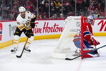 Mar 17, 2026; Montreal, Quebec, CAN; Boston Bruins right wing David Pastrnak (88) plays the puck behind Montreal Canadiens goalie Jakub Dobes (75) net during the first period at Bell Centre. Mandatory Credit: David Kirouac-Imagn Images