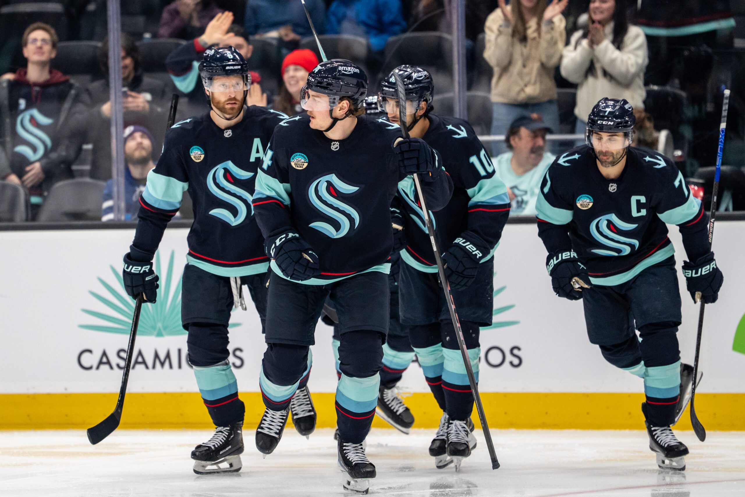 Mar 17, 2026; Seattle, Washington, USA; Seattle Kraken forward Bobby McMann (74), second from left, skates off the ice with defenseman Adam Larsson (6), left, forward Matty Beniers (10), and forward Jordan Eberle (7) after scoring a goal during the second period against the Tampa Bay Lightning at Climate Pledge Arena. Mandatory Credit: Stephen Brashear-Imagn Images