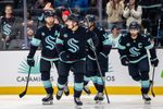 Mar 17, 2026; Seattle, Washington, USA; Seattle Kraken forward Bobby McMann (74), second from left, skates off the ice with defenseman Adam Larsson (6), left, forward Matty Beniers (10), and forward Jordan Eberle (7) after scoring a goal during the second period against the Tampa Bay Lightning at Climate Pledge Arena. Mandatory Credit: Stephen Brashear-Imagn Images
