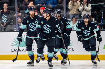 Mar 17, 2026; Seattle, Washington, USA; Seattle Kraken forward Bobby McMann (74), second from left, skates off the ice with defenseman Adam Larsson (6), left, forward Matty Beniers (10), and forward Jordan Eberle (7) after scoring a goal during the second period against the Tampa Bay Lightning at Climate Pledge Arena. Mandatory Credit: Stephen Brashear-Imagn Images