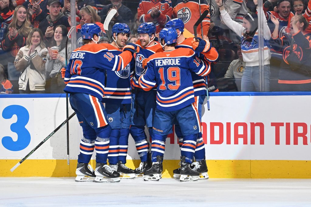 Mar 17, 2026; Edmonton, Alberta, CAN; Edmonton Oilers center Trent Frederic (10) with defenseman Evan Bouchard (2) left winger Max Jones (46) and center Adam Henrique (19) celebrate a goal on San Jose Sharks goalie Alex Nedeljkovic (33) (not pictured) during the third period at Rogers Place. Mandatory Credit: Walter Tychnowicz-Imagn Images