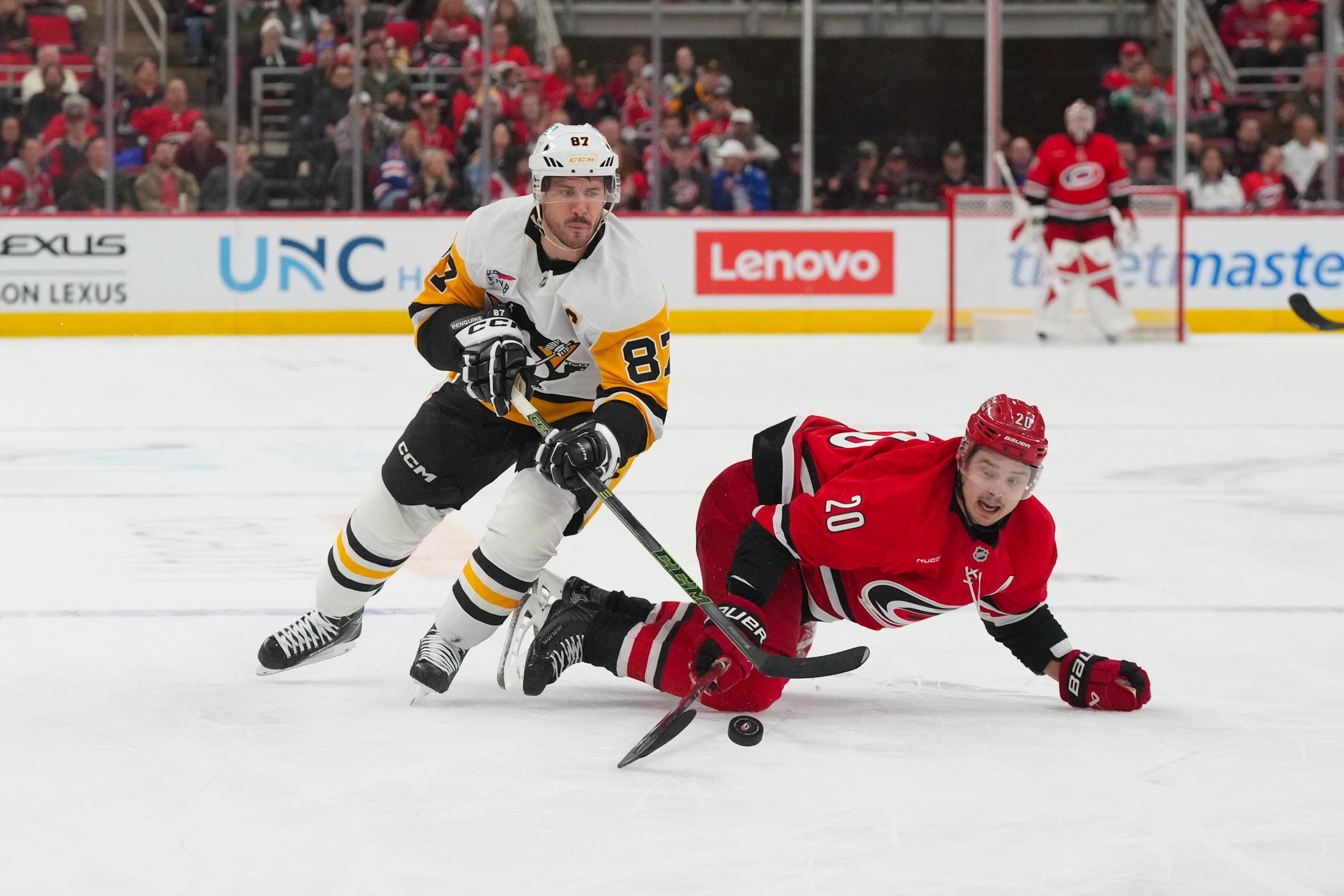 Mar 18, 2026; Raleigh, North Carolina, USA;  Carolina Hurricanes center Sebastian Aho (20) and Pittsburgh Penguins center Sidney Crosby (87) battle over the puck during the third period at Lenovo Center. Mandatory Credit: James Guillory-Imagn Images