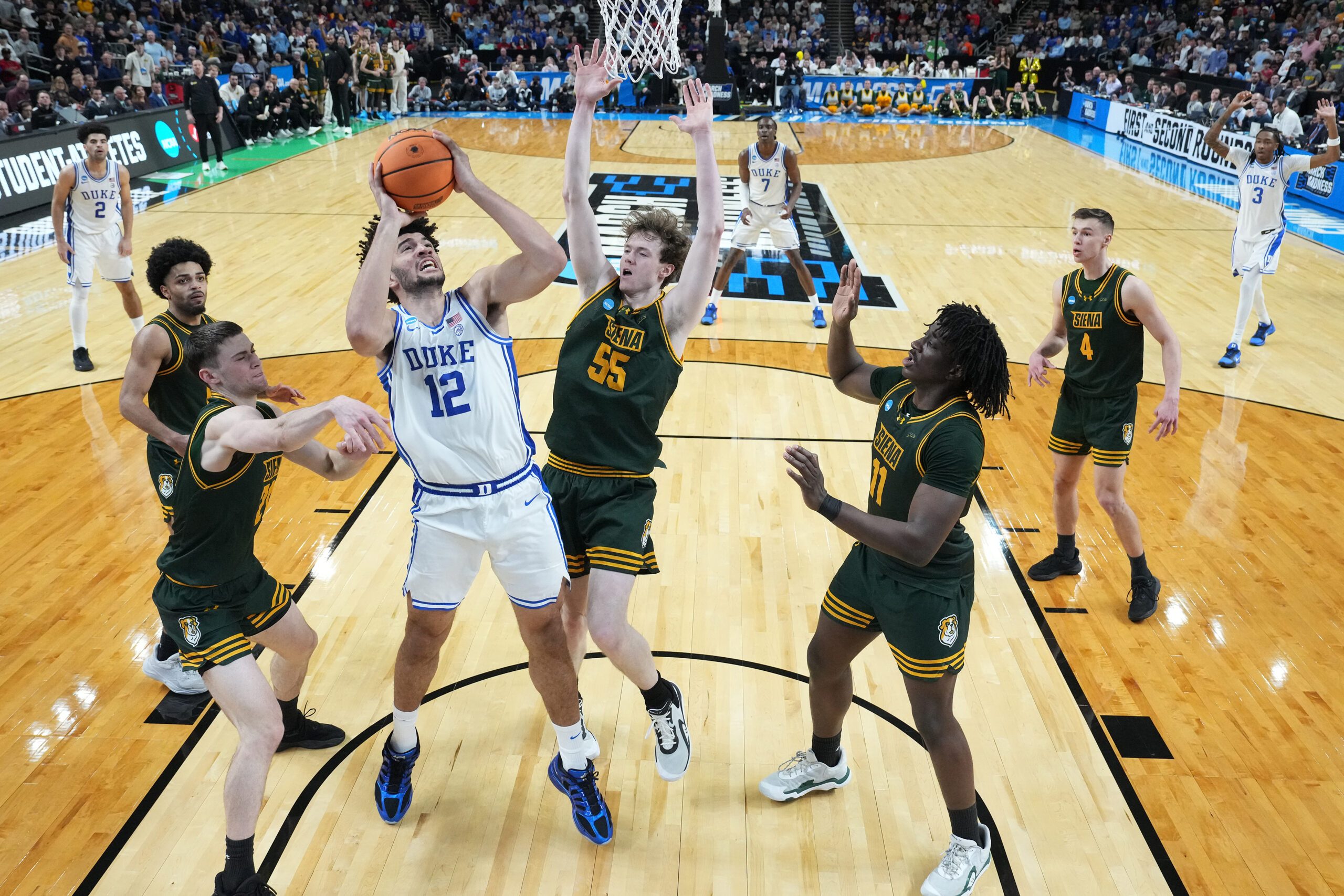 Mar 19, 2026; Greenville, SC, USA; Duke Blue Devils forward Cameron Boozer (12) shoots the ball over Siena Saints center Riley Mulvey (55) in the second half during a first round game of the men's 2026 NCAA Tournament at Bon Secours Wellness Arena. Mandatory Credit: Bob Donnan-Imagn Images