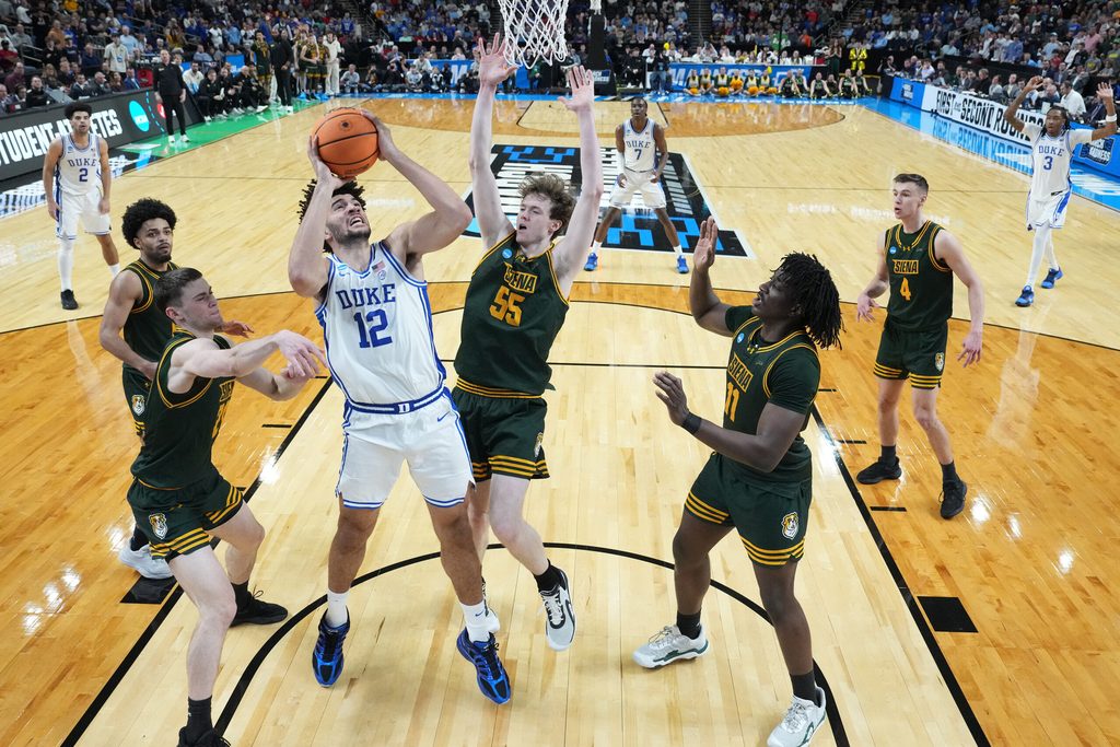 Mar 19, 2026; Greenville, SC, USA; Duke Blue Devils forward Cameron Boozer (12) shoots the ball over Siena Saints center Riley Mulvey (55) in the second half during a first round game of the men's 2026 NCAA Tournament at Bon Secours Wellness Arena. Mandatory Credit: Bob Donnan-Imagn Images