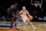 Nebraska Cornhuskers guard Sam Hoiberg (1) dribbles beside Troy Trojans forward Jerrell Bellamy (10) during a first-round game in the NCAA men's basketball tournament between Nebraska and Troy at Paycom Center in Oklahoma City, Thursday, March 19, 2026.