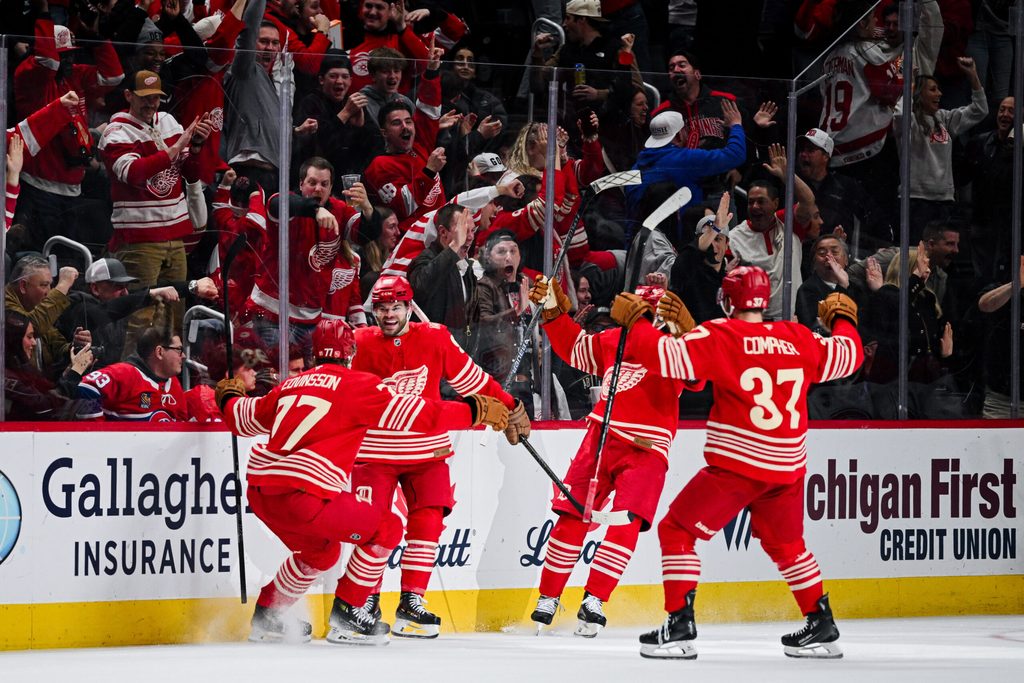 Mar 19, 2026; Detroit, Michigan, USA; Detroit Red Wings right wing Alex DeBrincat (93) celebrates with defenseman Simon Edvinsson (77) and left wing J.T. Compher (37) after scoring a goal during the third period against the Montreal Canadiens at Little Caesars Arena. Mandatory Credit: Tim Fuller-Imagn Images