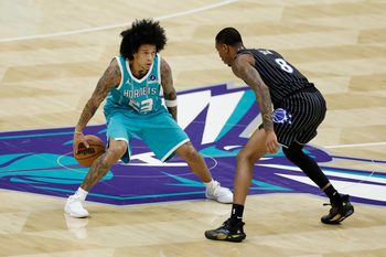 Mar 19, 2026; Charlotte, North Carolina, USA; Charlotte Hornets guard Tre Mann (23) is guarded by Orlando Magic forward Jamal Cain (8) during the fourth quarter at Spectrum Center. Mandatory Credit: Brian Westerholt-Imagn Images