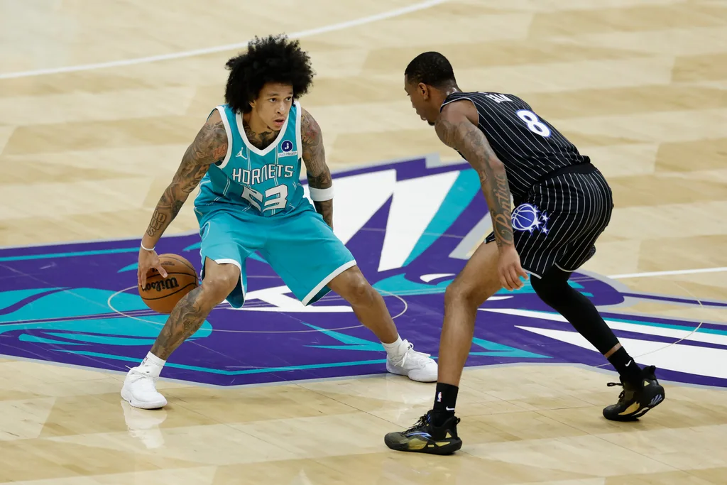 Mar 19, 2026; Charlotte, North Carolina, USA; Charlotte Hornets guard Tre Mann (23) is guarded by Orlando Magic forward Jamal Cain (8) during the fourth quarter at Spectrum Center. Mandatory Credit: Brian Westerholt-Imagn Images