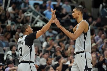 Mar 19, 2026; San Antonio, Texas, USA;  San Antonio Spurs forwards Keldon Johnson (3) and Victor Wembanyama (1) celebrate in the second half against the Phoenix Suns at Frost Bank Center. Mandatory Credit: Daniel Dunn-Imagn Images