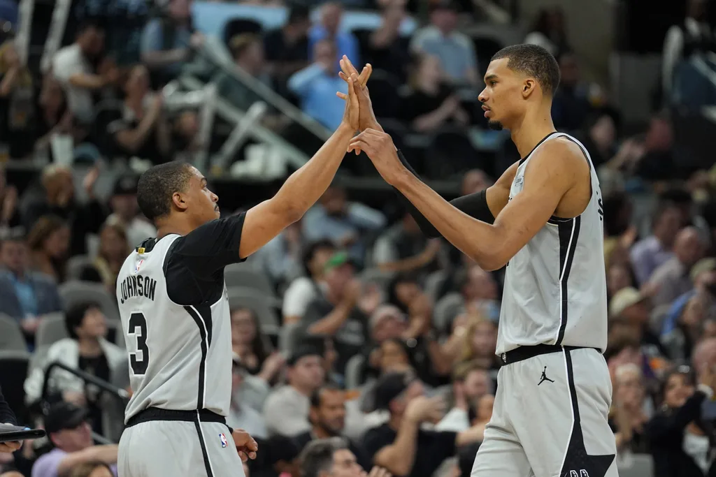 Mar 19, 2026; San Antonio, Texas, USA; San Antonio Spurs forwards Keldon Johnson (3) and Victor Wembanyama (1) celebrate in the second half against the Phoenix Suns at Frost Bank Center. Mandatory Credit: Daniel Dunn-Imagn Images