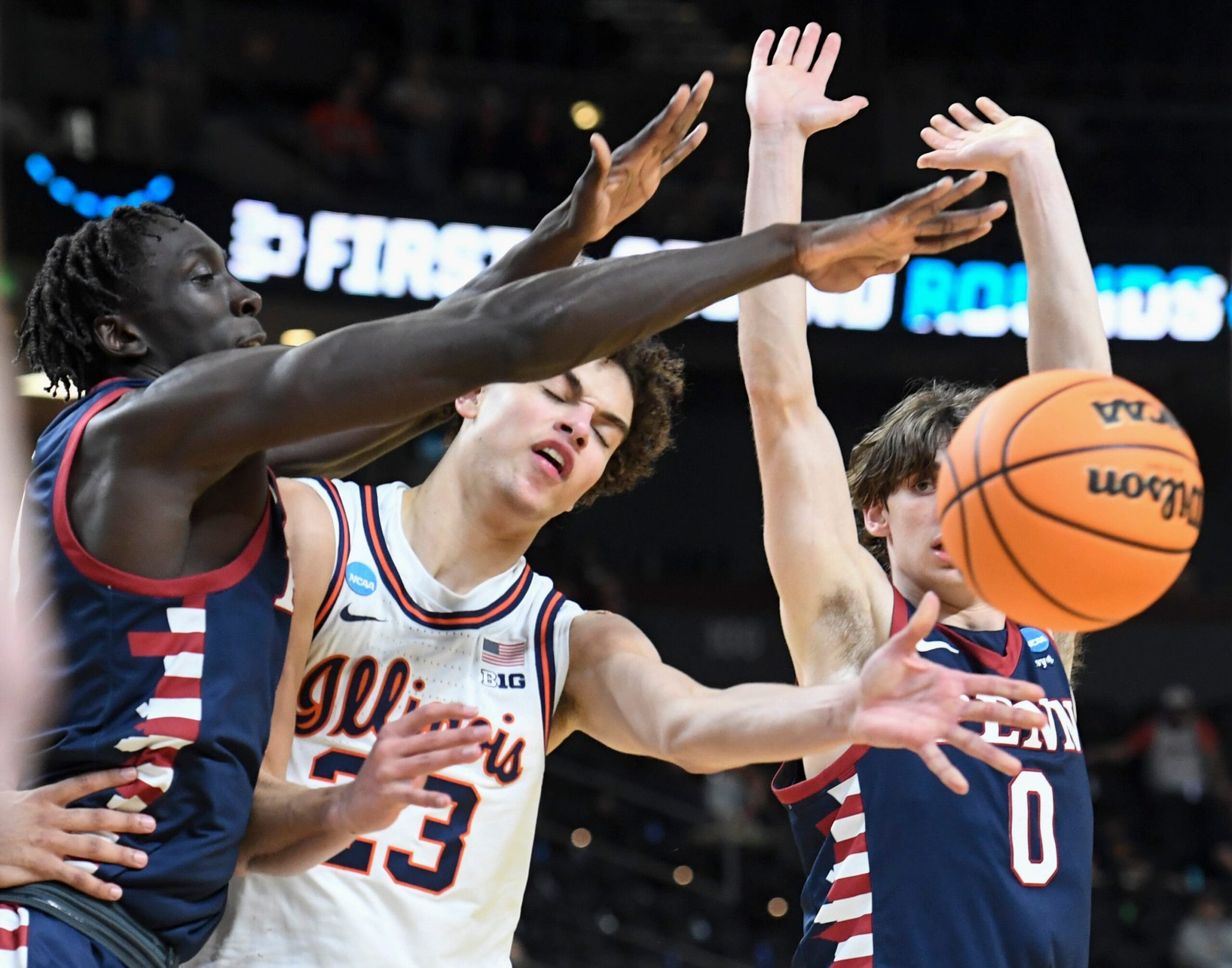 Penn Quakers forward Lucas-Allan Lueth (30) and Penn Quakers guard AJ Levine (0) defend Illinois Fighting Illini guard Keaton Wagler (23) Thursday, March 19, 2026, during the NCAA Men’s Basketball Tournament first round game at Bon Secours Wellness Arena in Greenville, South Carolina. Illinois Fighting Illini won 105-70.