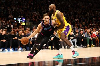 Mar 19, 2026; Miami, Florida, USA; Miami Heat guard Pelle Larsson (9) drives to basket against Los Angeles Lakers forward LeBron James (23) during second half at Kaseya Center. Mandatory Credit: Isabella Frias-Imagn Images