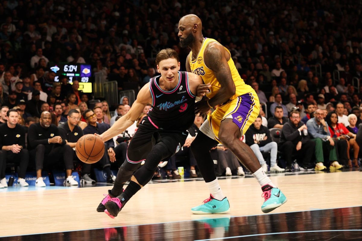 Mar 19, 2026; Miami, Florida, USA; Miami Heat guard Pelle Larsson (9) drives to basket against Los Angeles Lakers forward LeBron James (23) during second half at Kaseya Center. Mandatory Credit: Isabella Frias-Imagn Images
