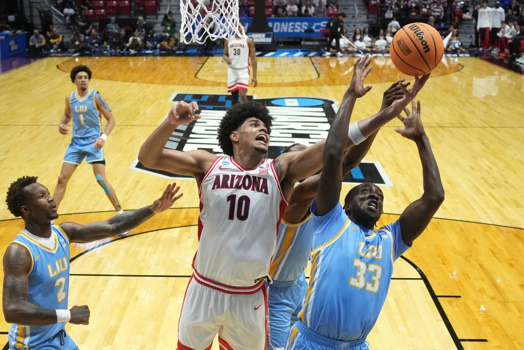 Mar 20, 2026; San Diego, CA, USA; Arizona Wildcats forward Koa Peat (10) and LIU Sharks forward Jamal Fuller (33) reach for the rebound in the first half during a first round game of the men's 2026 NCAA Tournament at Viejas Arena. Mandatory Credit: Kirby Lee-Imagn Images