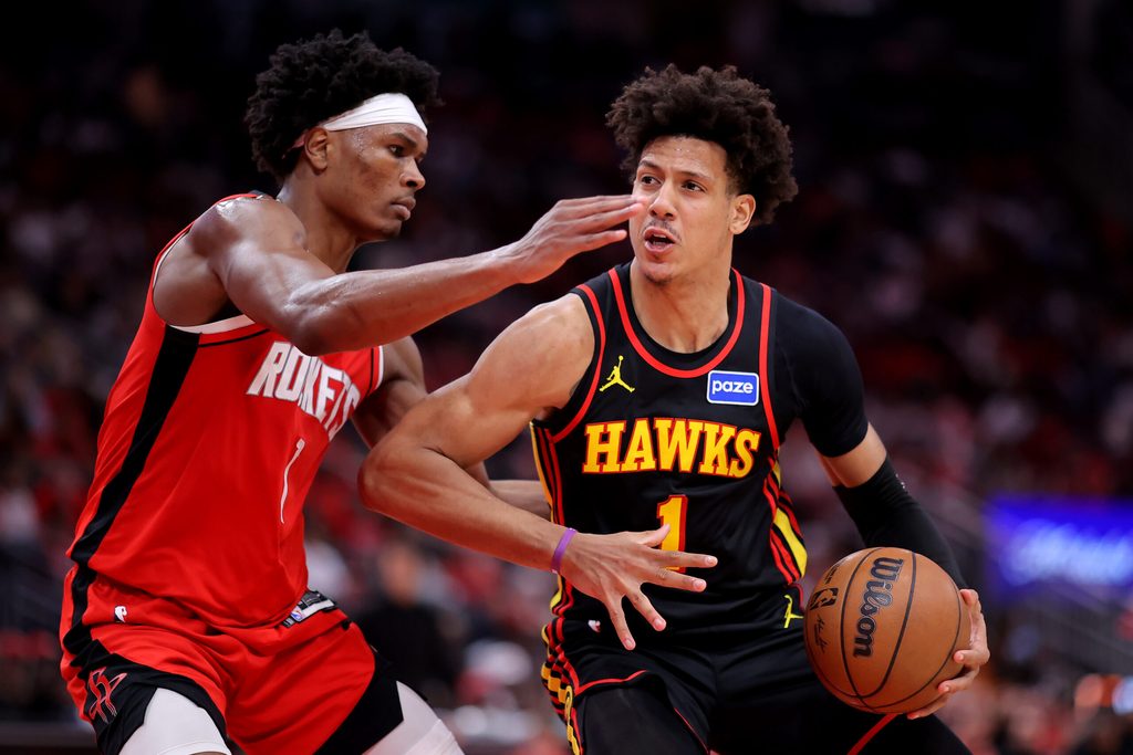 Mar 20, 2026; Houston, Texas, USA; Atlanta Hawks forward Jalen Johnson (1) drives to the basket against Houston Rockets guard Amen Thompson (1) during the fourth quarter at Toyota Center. Mandatory Credit: Erik Williams-Imagn Images